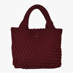 Cherry red woven mini tote bag with top handles and a soft textured finish