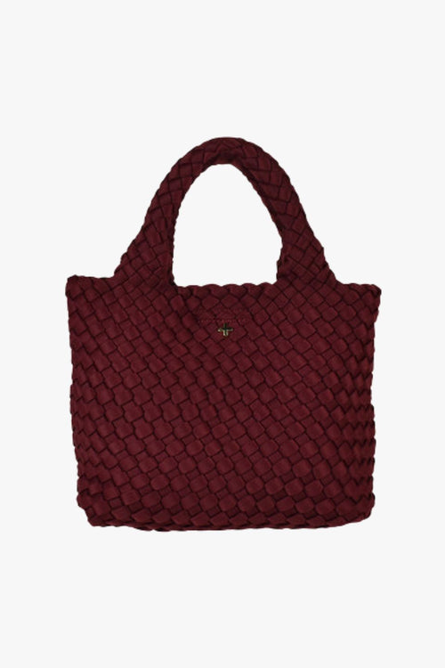 Cherry red woven mini tote bag with top handles and a soft textured finish