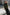 Woman in a green sweater standing in front of classical architecture
