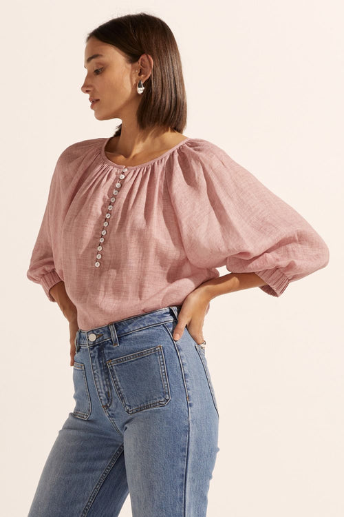 model wears a pink linen blouse