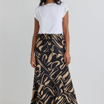 model wears a black and beige pattern maxi skirt