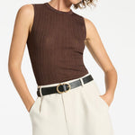 woman wearing black leather belt with gold buckle
