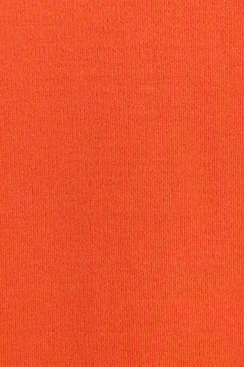 A close-up texture shot of a solid orange knit fabric, showing the fine ribbed weave pattern.
