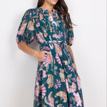 Woman wearing a floral dress against a white background