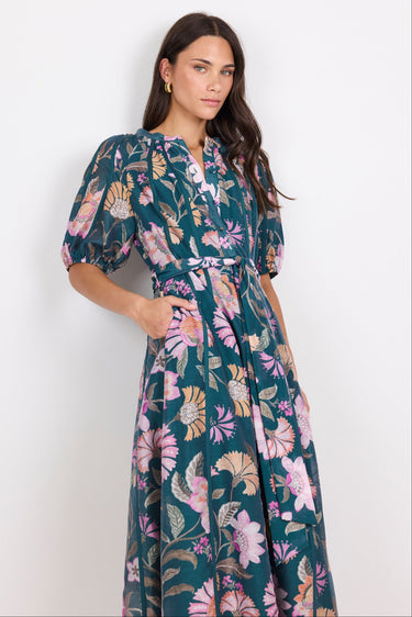 Woman wearing a floral dress against a white background