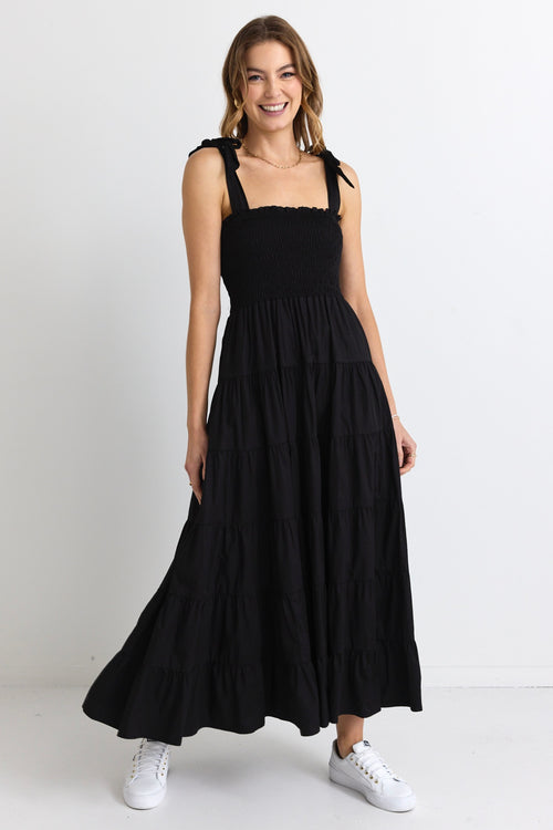 model wears a black strappy maxi dress