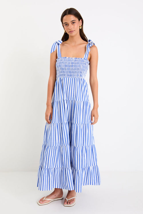 Woman wears a blue white striped maxi dress