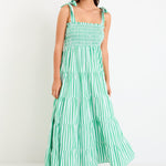 Woman wears a green and white striped maxi dress