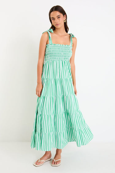 Woman wears a green and white striped maxi dress