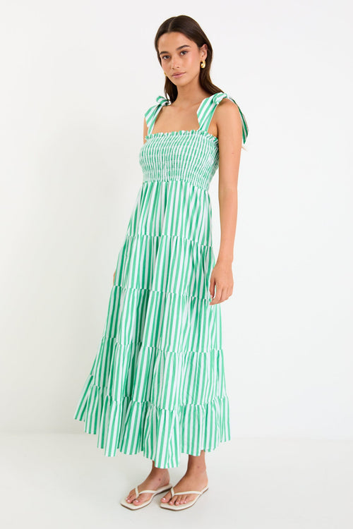 Woman wears a green and white striped maxi dress