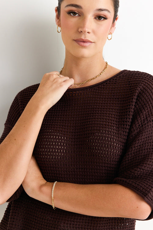 model wears a brown knit tee