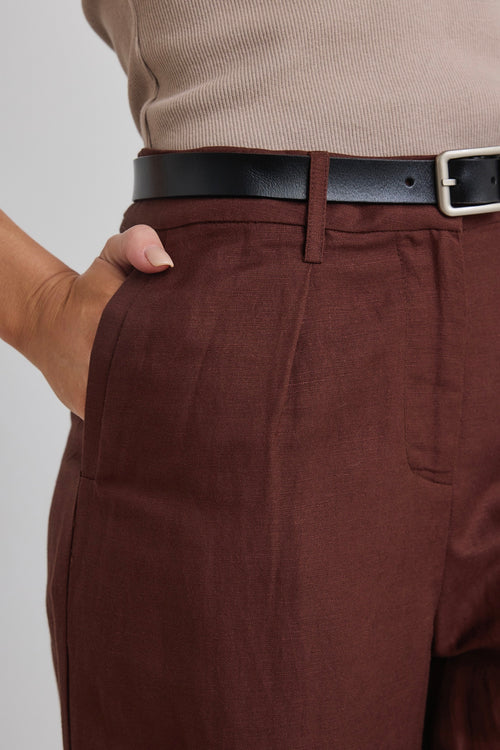 model wears brown linen pants