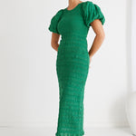 model wears a green midi dress