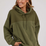 woman wearing green hoodie and blue jeans