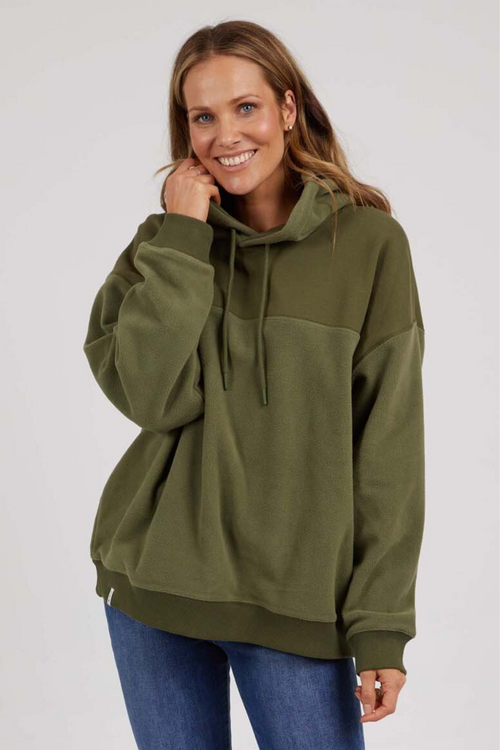 woman wearing green hoodie and blue jeans