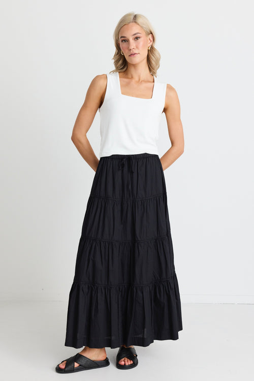 model wears a black maxi skirt 