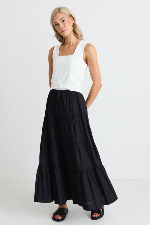 model wears a black maxi skirt 