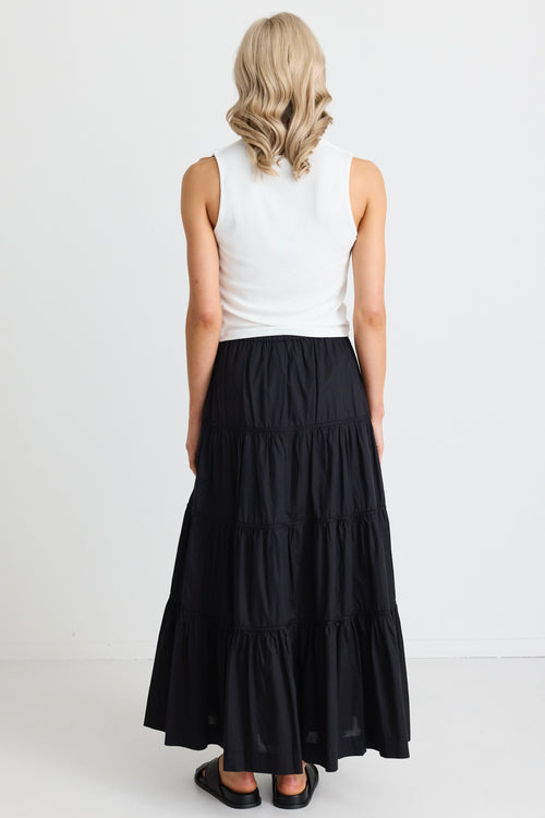 model wears a black maxi skirt 