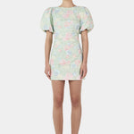 Woman wearing a green floral mini dress