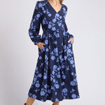 model wears a blue long sleeve floral dress