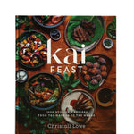 Book cover of 'kai FEAST' with images of food on a wooden table