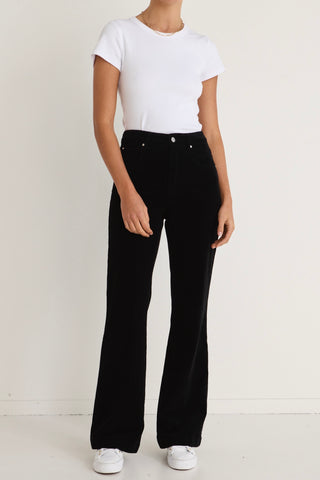 model wears a black cord jeans