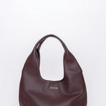 Brown leather handbag on a white background
