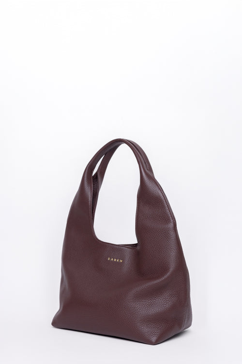 Brown leather handbag on a white background