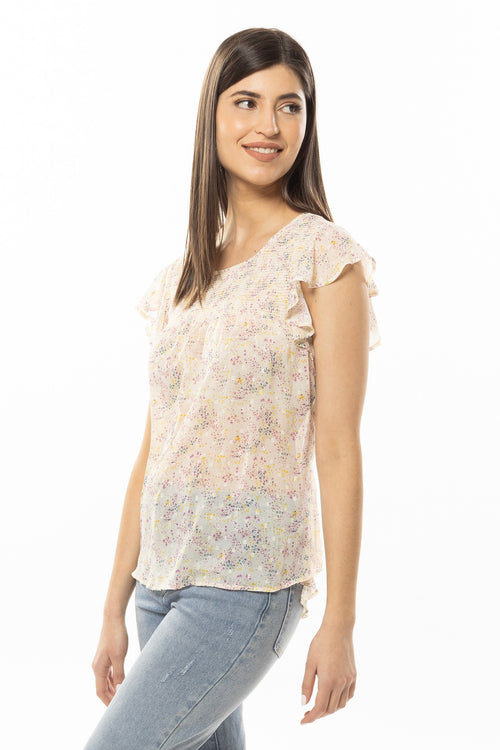 model wears a white floral top with jeans