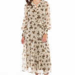 model wears a beige maxi dress