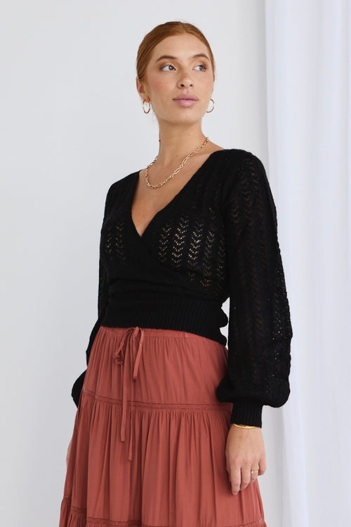 model wears a black knit top 