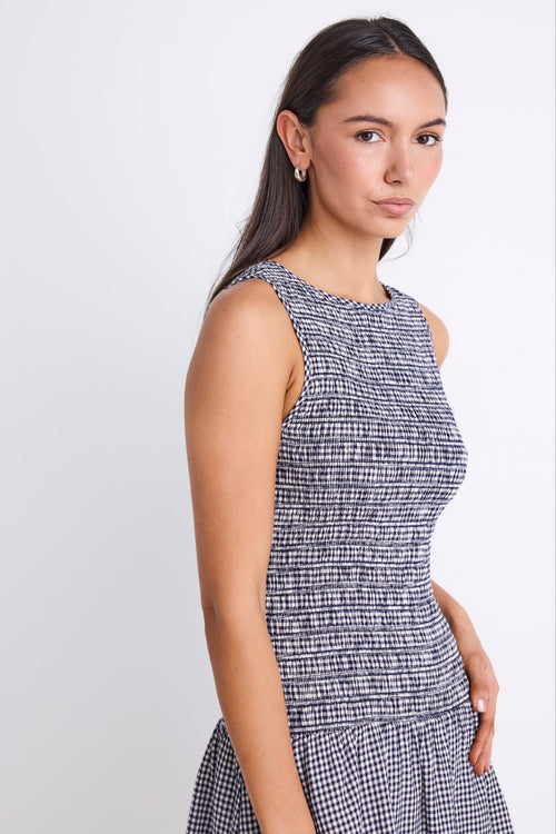 woman wearing navy gingham mini dress