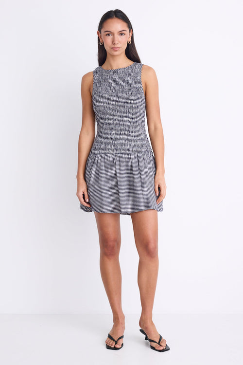 woman wearing navy gingham mini dress