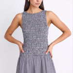 woman wearing navy gingham mini dress