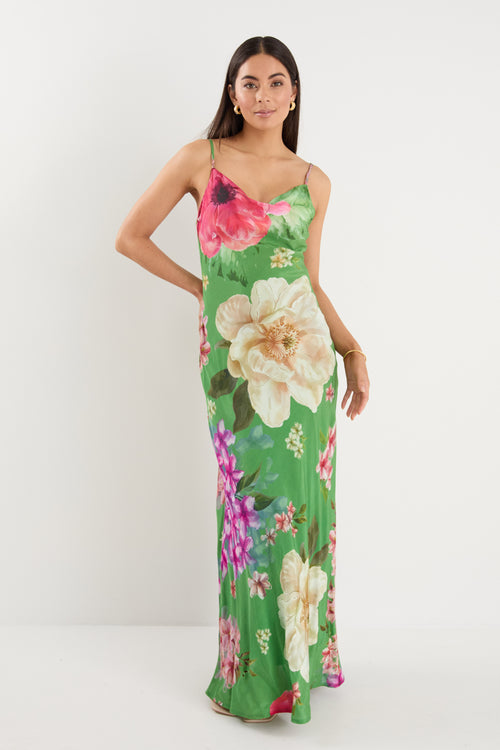 model wears a green floral maxi dress