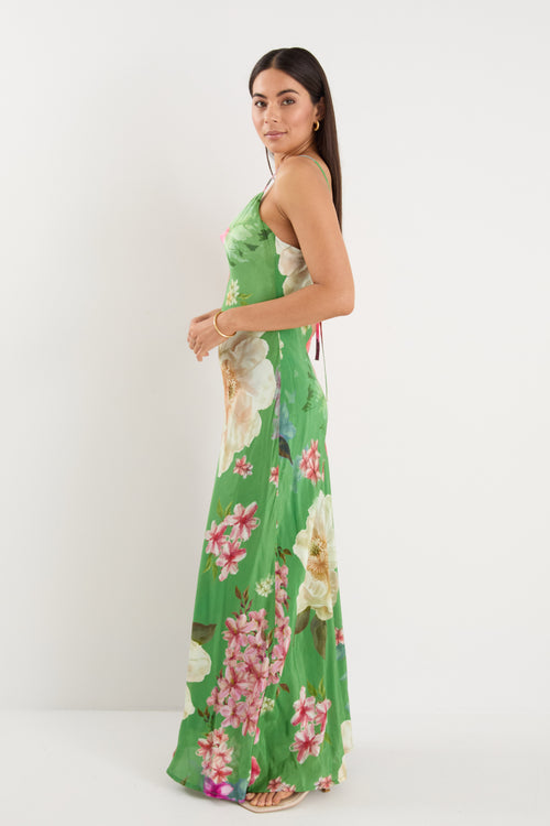 model wears a green floral maxi dress
