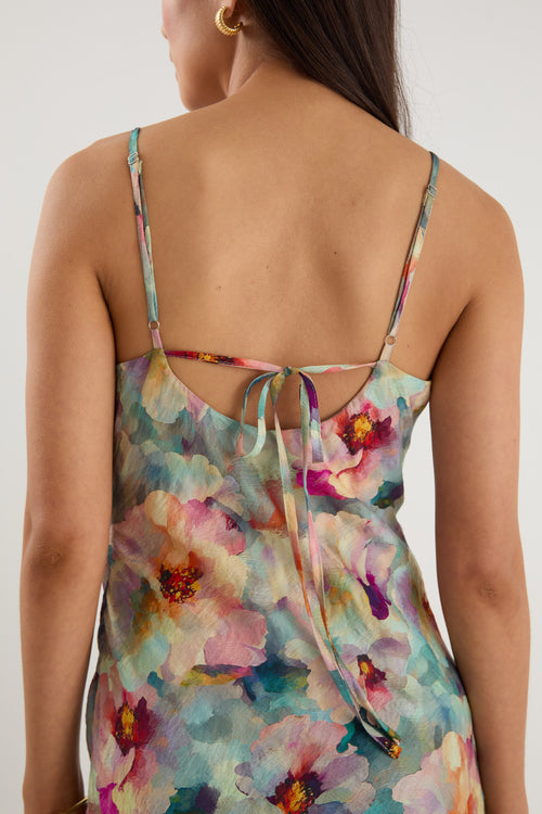 model wears a blue floral maxi dress with white heels