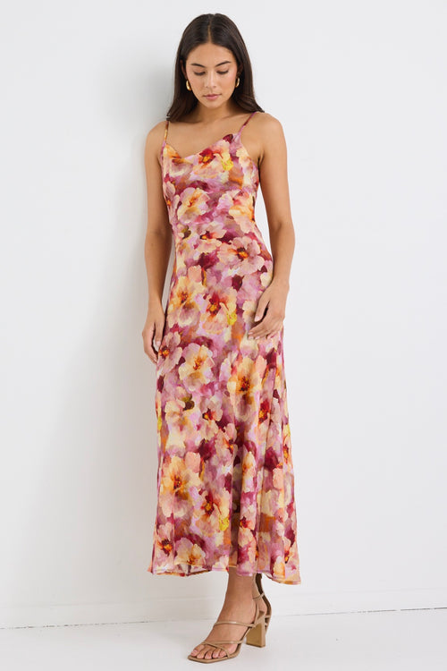 model wears a pink floral maxi dress
