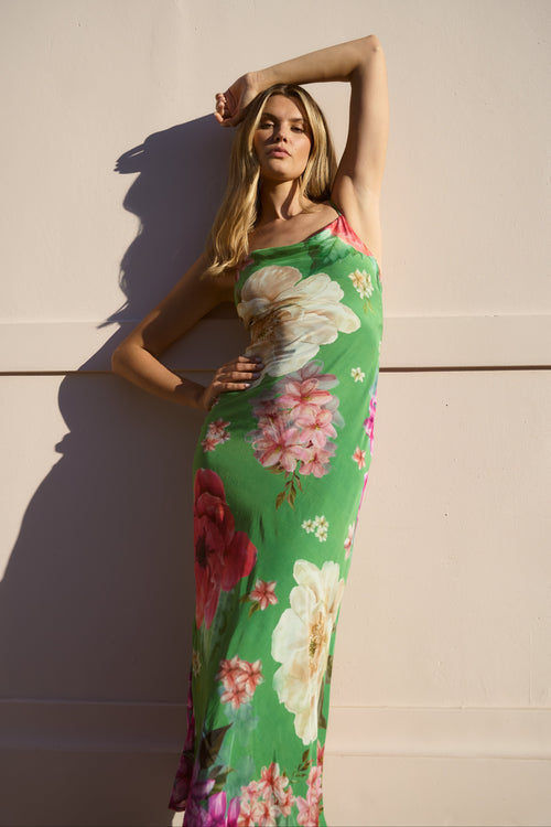 Model wearing a green floral print dress

