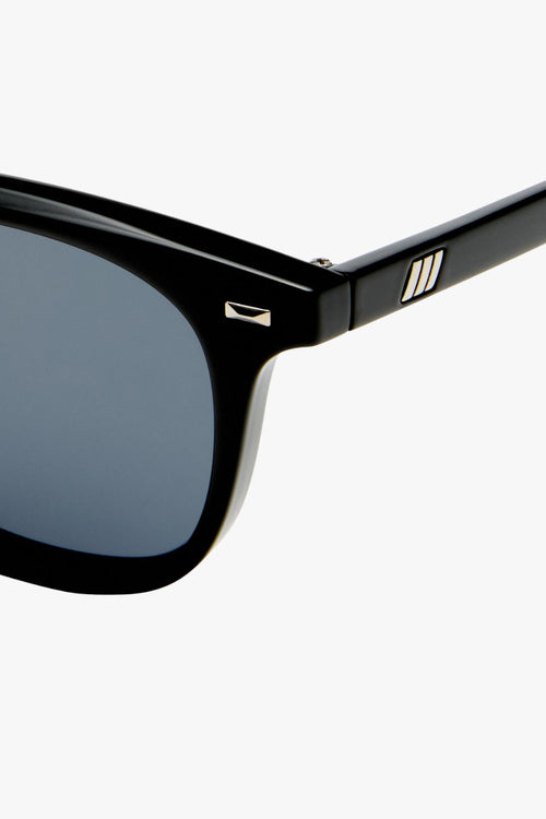 Black rounded sunglasses with smoke-tinted polarized lenses, shown front-facing on a white background.