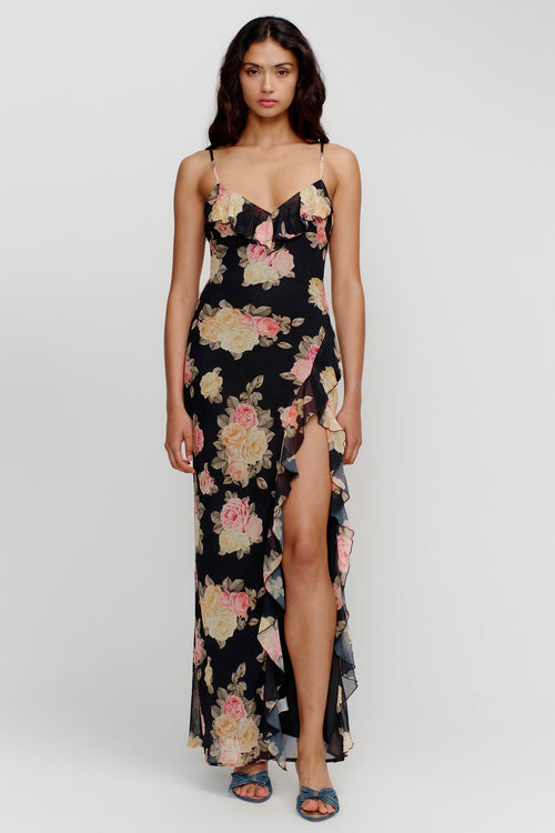 model wears a black floral maxi dress