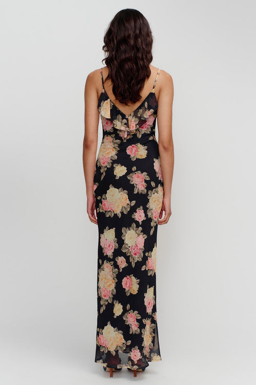 model wears a black floral maxi dress