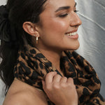 woman wearing leopard print scarf