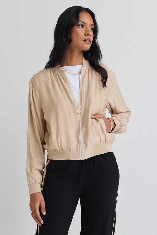 model wears a beige jacket