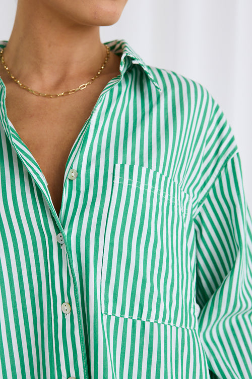 model wears a green stripe shirt