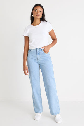 model wears light blue jeans with a white tee