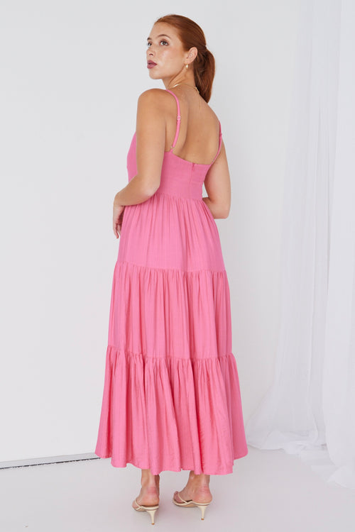 model wears a pink strappy maxi dress