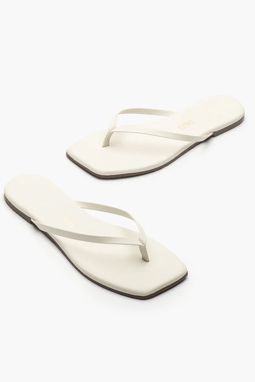 Pair of white flip-flops on a white background