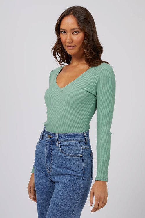 model wears a green rib long sleeve top