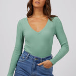 model wears a green rib long sleeve top